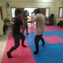 Another moment from a kumite session, showing students exchanging techniques and applying what they have learned in drills.