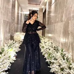 A full-length view of the sparkling black ethnic co-ord set. The sheer sleeves and detailed embroidery make it a sophisticated choice for any formal event.