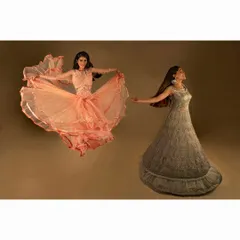 A composite image showing two models in flowing gowns. This studio shot plays with movement and form to create a magical, dreamlike quality for a fashion campaign.