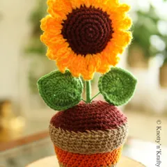 Brighten up your space with a little handmade sunshine. This cheery sunflower stands tall in its textured crochet pot, stitched with love to bring joy to any corner of your home.