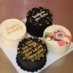 This set of four mini cakes was designed for a 29th birthday, featuring a mix of elegant and witty themes. We love the black and gold cakes with funny quotes next to the cute Lotso bear design.