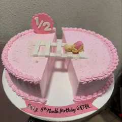 A creative half-birthday cake, designed as two semi-circles to represent the "1/2" milestone. It's a lovely way to celebrate six months of joy.