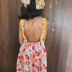Another look at our whimsical floral backless frock. The details on the back make it so special, and the soft cotton ensures it's comfortable enough for all-day wear.