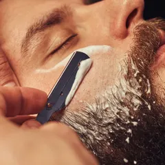 Experience the classic straight razor shave, a ritual of refinement. We use hot towels and premium balms to deliver an impeccably close and comfortable shave, leaving your skin smooth and revitalized.