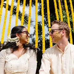 A candid moment between the bride and groom against a backdrop of marigold curtains. I focus on creating a relaxed atmosphere where you can share genuine smiles and laughter.