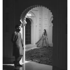 Playing with light and shadow to create a dramatic, artistic pre-wedding portrait. This black and white shot at Udaivilas adds a touch of timeless romance and mystery.
