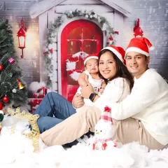 The perfect family Christmas card photo. The whole family, dressed in cozy sweaters and Santa hats, shares a happy moment in our festive studio setup.