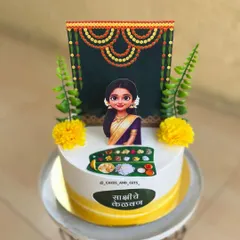 A close-up of another Kelvan cake, this one for the bride-to-be, Sakshi. The topper is designed to look just like her, complete with a traditional saree and backdrop.