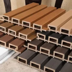 A close-up of our WPC louver panels stacked together. You can clearly see the hollow, durable structure and the variety of wood-tone finishes, perfect for both indoor and outdoor use.