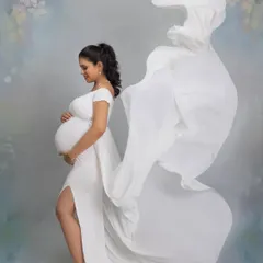 The magic of a fabric toss. The flowing white fabric of the gown creates a sense of angelic wings, adding drama and movement to this beautiful portrait.