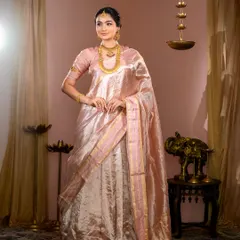 A full-length view of this ethereal look. The light pink silk saree drapes beautifully, and the makeup is kept classic and elegant to match.