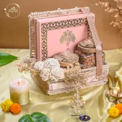 This elegant pink and gold hamper is a popular choice for Diwali. It includes a beautiful box of assorted sweets and jars of premium nuts, all arranged in a reusable basket adorned with delicate floral details.