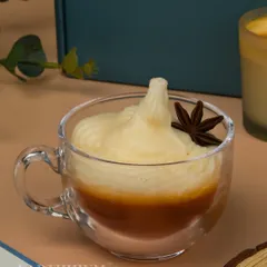 My Whipped Hot Chocolate candle, served in a glass teacup, is the definition of cozy. It's topped with wax whipped cream and a star anise.