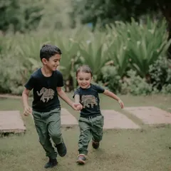 The bond between brothers is something special. I captured this candid moment of them running hand in hand during an outdoor sibling photoshoot. My goal is to photograph these connections as they truly are, full of energy and affection.