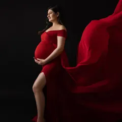 A powerful and dramatic fabric toss with a bold red gown against a black background. This technique creates stunning, high-impact images.