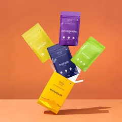 A dynamic floating shot of One Living's Immunity Kit. To achieve this levitation effect, we photographed each packet individually on hidden supports and then composited them together in post-production for a seamless, gravity-defying result.