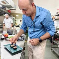 In the kitchen, every detail matters. A glimpse of me focused on the intricate task of plating, because excellence is in the details.