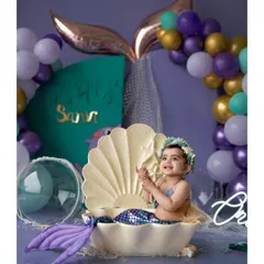 A pearl from the ocean. Our 'Little Mermaid' theme features a beautiful clamshell prop, perfect for creating an enchanting underwater world for your baby's photoshoot.