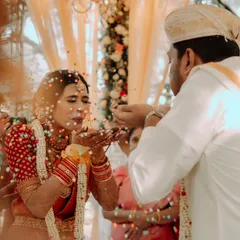 A moment of pure fun and blessings during the Talambralu ritual. The air is filled with pearls and rice, and more importantly, with the couple's infectious laughter and joy.