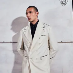 A full look of the Ivory Industrial suit. The double-breasted silhouette is given a contemporary update with sharp contrast piping and bold hardware, creating a look of polished presence.