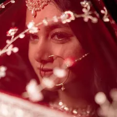 A bridal portrait is about capturing a feeling. Here, I focused on an intimate close-up, highlighting the delicate embroidery on the red veil and the traditional nath jewelry, creating a timeless and emotional shot for the bride.