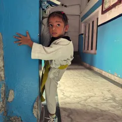 Another one of my young students, inspired by the greats, holding a perfect standing split against the wall.