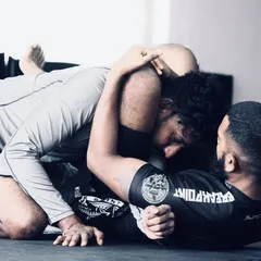 A great shot from a BJJ rolling session. This shows the intensity and focus required in grappling. We constantly work on winning these small moments, improving our position, and looking for the submission.