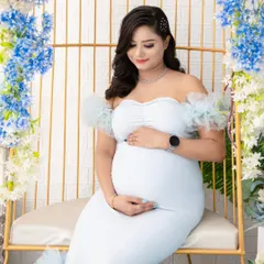 A closer look at our enchanted floral set. Featuring a golden birdcage chair and adorned with beautiful blue and white flowers, this setup is perfect for creating dreamy, fairy-tale maternity portraits.