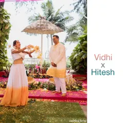 The bride playfully showers her groom with flower petals during their Haldi ceremony, a perfect candid shot full of life.