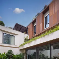 The facade of a home should be experienced from within, not just admired from the street. For this large residence, I used a dual-tone palette of French Beige marble and rust-finished boards to create a dynamic visual experience from every vantage point.