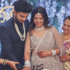 A sweet moment during the cake cutting ceremony. The makeup is designed to look flawless from every angle, even in candid shots.