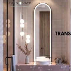 A chic bathroom with pink terrazzo countertops and small square wall tiles. The backlit arched mirror and modern pendant lights add a touch of elegance and provide excellent lighting.