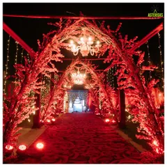 A breathtaking entrance for a night to remember. We designed this stunning red floral tunnel, complete with elegant chandeliers, to create a grand and romantic welcome for a reception at Sula Vineyards.