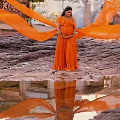 Our mustard georgette gown features four separate trails for a unique, wing-like effect. It's a vibrant and dynamic choice for a memorable maternity or pre-wedding shoot.