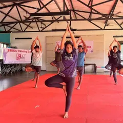 A warrior's strength comes from balance. We incorporate yoga into our camps to improve flexibility, focus, and recovery. Here, our students practice the Tree Pose (Vrikshasana) to build stability and mental calm.