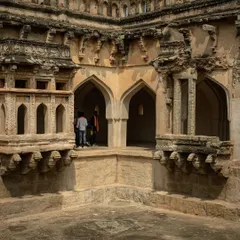 The Queen's Bath in Hampi, showcasing the intricate archways and design. I focus on details that tell the story of the structure's history and purpose.