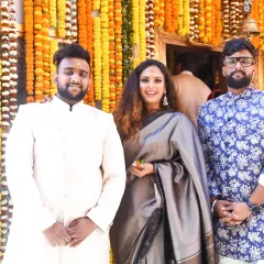 Attending my sister's wedding with my brothers. I opted for a sophisticated grey saree, which stands out beautifully against the vibrant marigold decor. This is a great Indian wedding guest style inspiration.