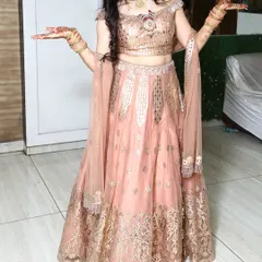 This image showcases the full twirl-worthy lehenga and the accompanying rental jewellery. The off-shoulder blouse draws attention to the statement necklace, making it a central part of the outfit.