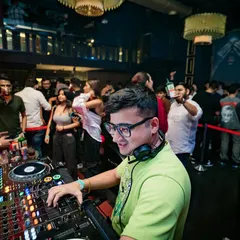 A quiet moment of focus at the decks, finding the next track to keep the energy flowing.