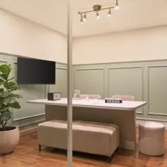 This is our primary discussion room, where we meet with clients. The space is designed to be comfortable and professional, with a large central table, bench seating, and good lighting for reviewing plans and materials.