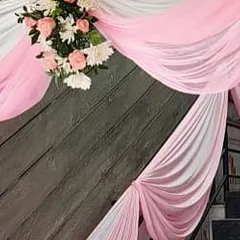 We pay attention to every detail, including decorating stairways with drapes and floral accents to create a cohesive look throughout the venue.