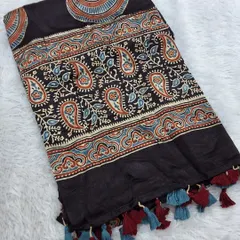 This Ajrakh modal fabric with a paisley border and tassels is perfect as a dupatta or for tailoring. The rich colors and soft texture make it a luxurious choice.