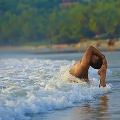 Practicing an advanced asana amidst the waves at Gokarna beach. The ocean teaches us that thoughts and feelings are like waves, they come and go. Through yoga, we find the part of us that remains constant and calm, even in the midst of movement.