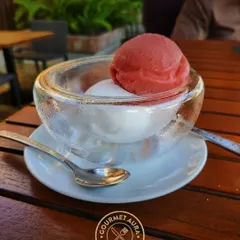 A refreshing scoop of strawberry and lemon sorbet served in a thick glass bowl. A perfect light dessert or palate cleanser.