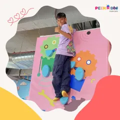 A young adventurer gives a thumbs-up after conquering our kid-friendly climbing wall. We offer a variety of physical challenges that are both safe and confidence-boosting for children of all ages.
