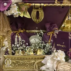 A closer look inside the Rajwada Chest, revealing velvet potlis, a delicate silver candle, and other curated items nestled amongst baby's breath. Each element is carefully placed to create a breathtaking unboxing experience for the recipient.
