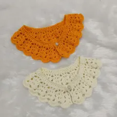 A pair of the lacy crochet collars, one in a sunny orange and the other in classic off-white. I can customize these in any color you'd like.