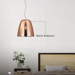 A hammered copper pendant provides a warm radiance beside the bed. The textured finish and warm light create a sense of embedded luxury, perfect for a serene bedroom.