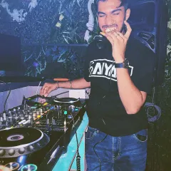 A candid moment behind the decks. Even during a set, there's always time for a quick slice of pizza to keep the energy up.