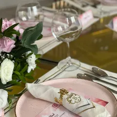 A customized table setting for a special occasion, featuring personalized menus and napkins, demonstrating our ability to tailor every detail to your event.